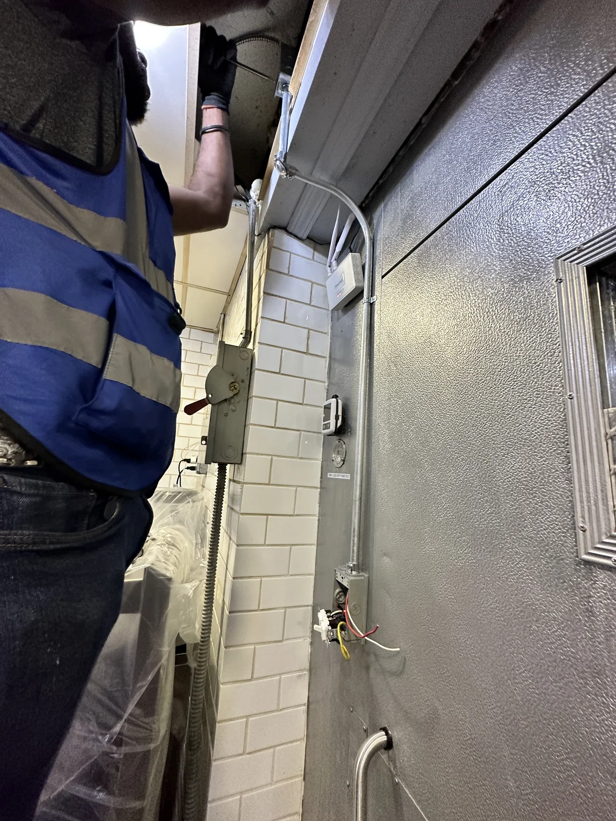 Open commercial electrical panels with breakers and wiring during field troubleshooting