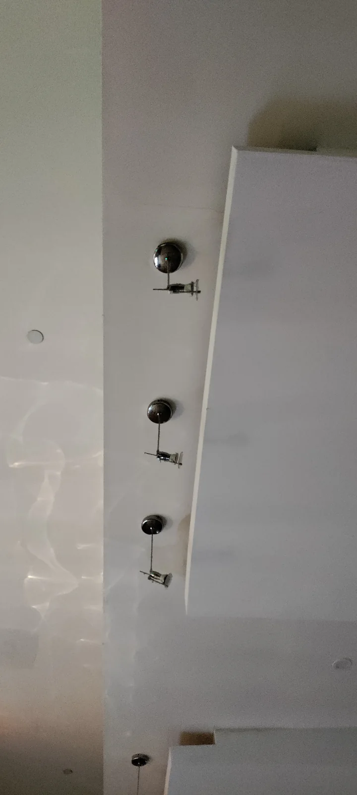 Completed recessed and ceiling lighting installation in a Brooklyn building hallway