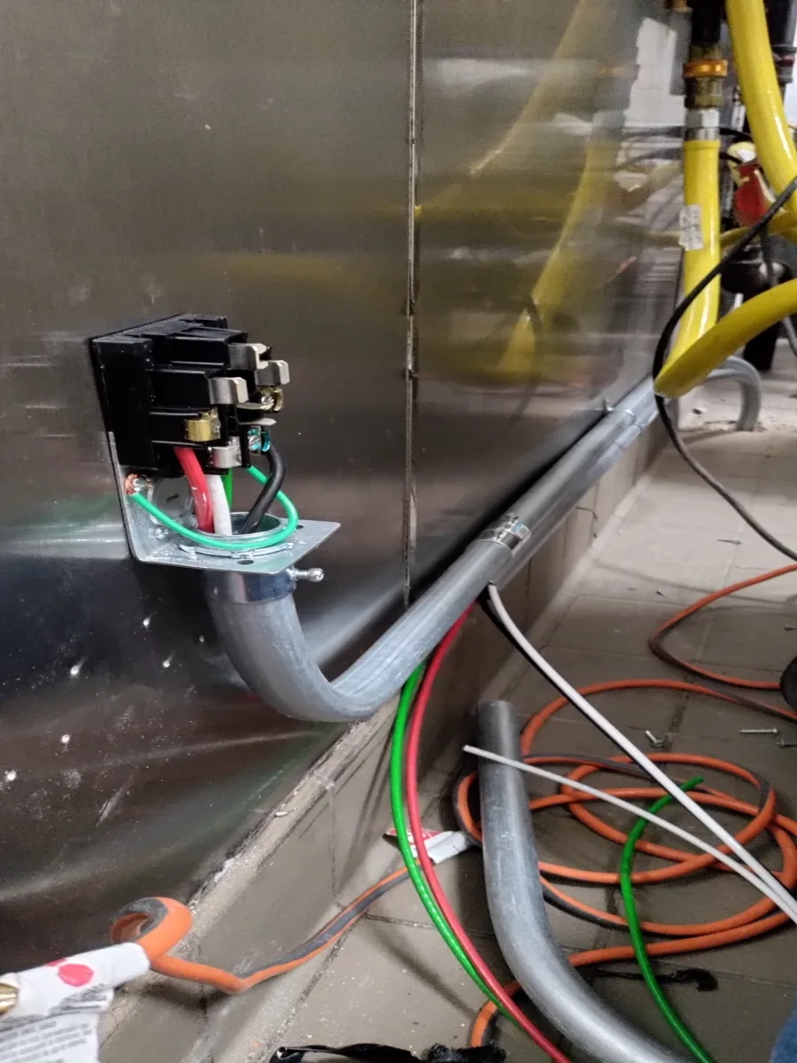 Electric range receptacle installation with conductor and conduit work at a New York City property