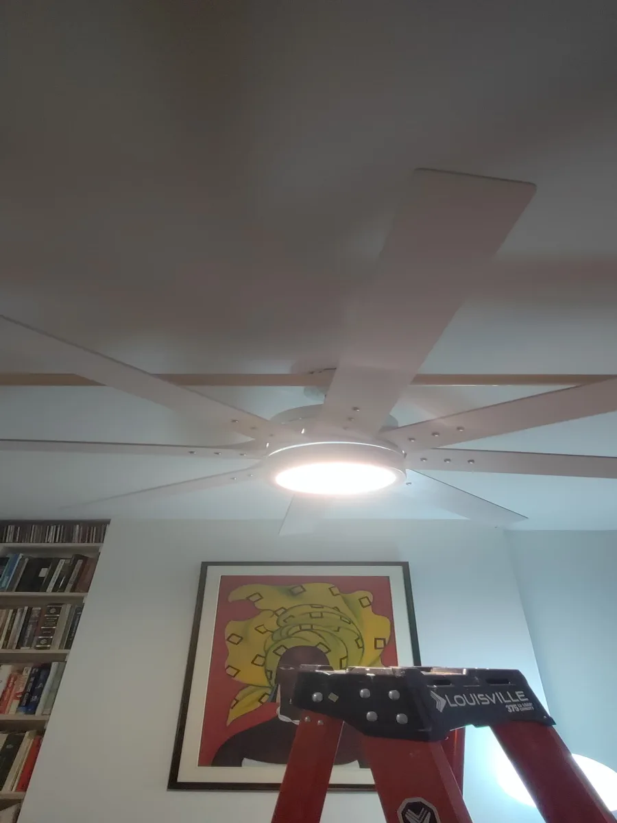 Finished ceiling-fan installation Finished white ceiling fan with integrated light at a New York City residence