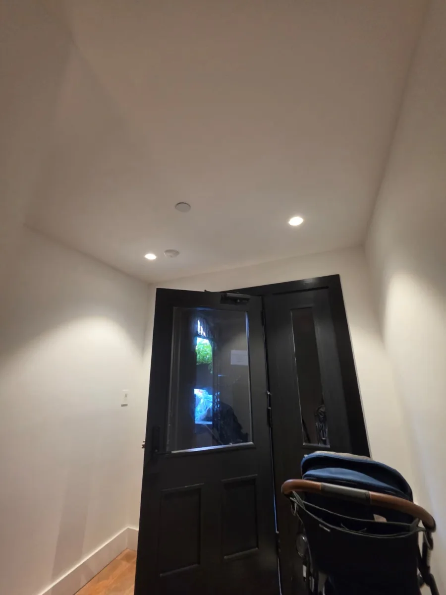 Finished recessed LED downlights in a New York City entry hallway