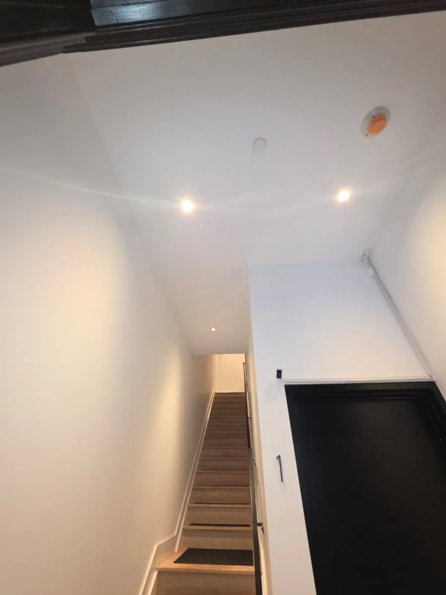 Finished recessed LED downlights lighting a New York City stair hallway