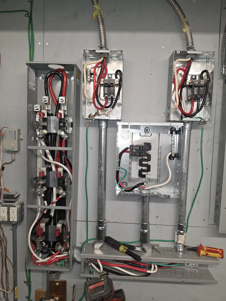 Electrical Service Upgrade Equipment in NYC Electrical service-upgrade equipment with service disconnects, panels, feeder conductors, and grounding conductors at a New York City property